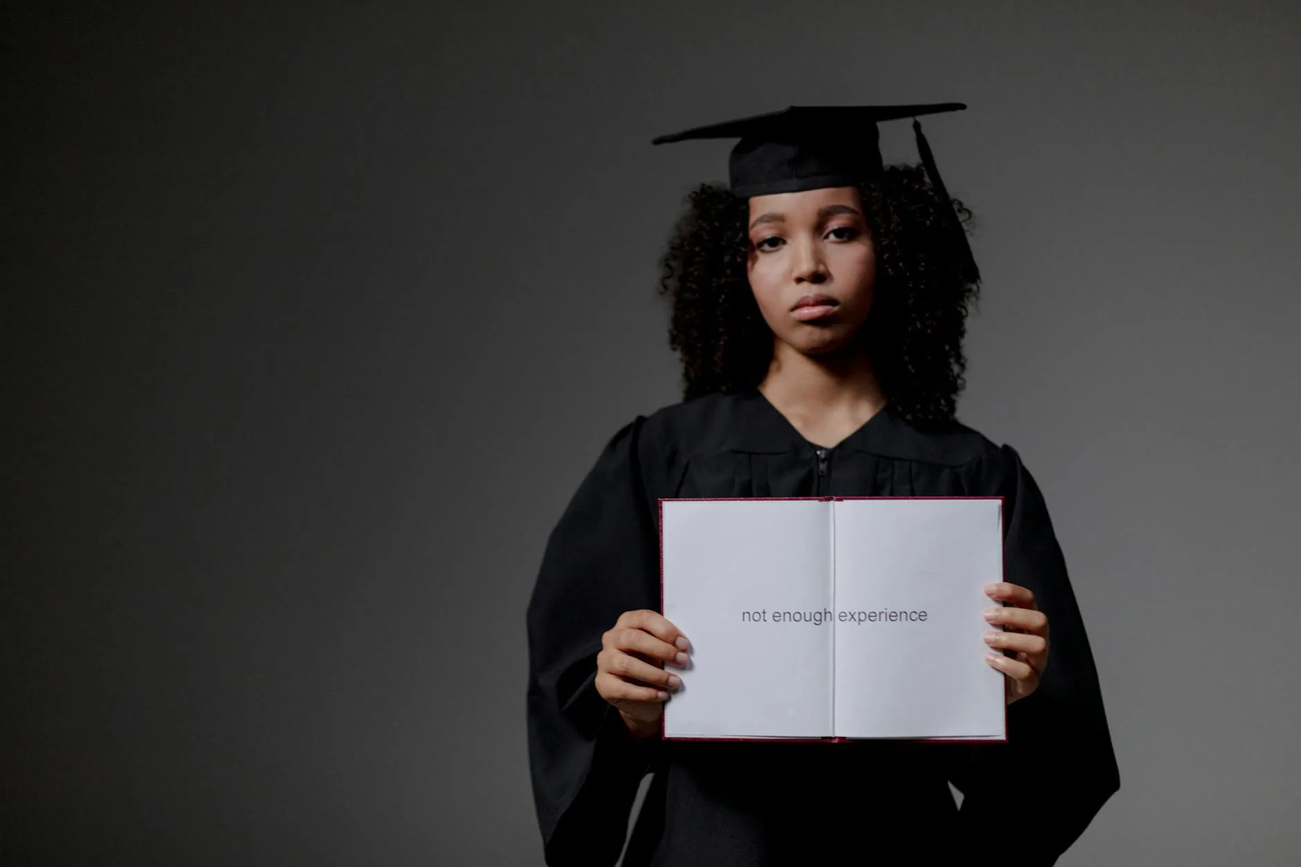 Young graduate holding a book with 