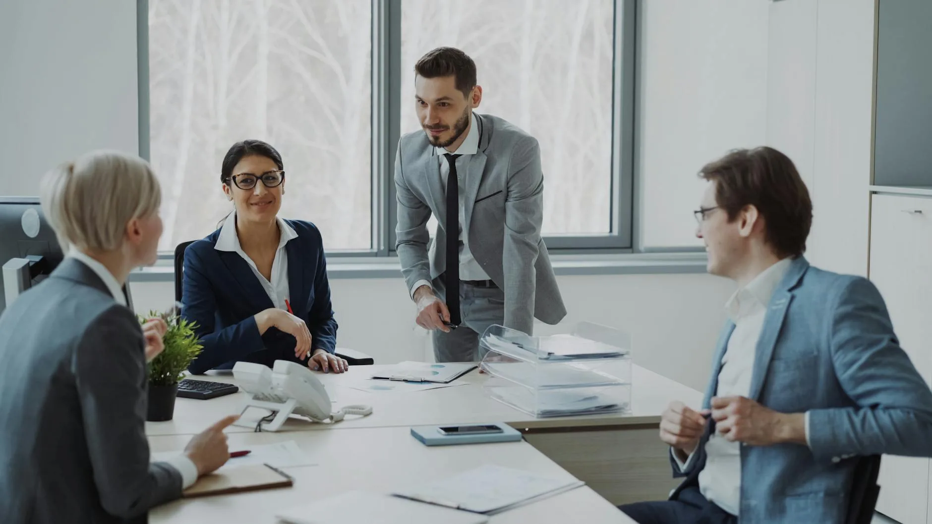 Group of professionals in a modern office setting discussing business strategies.